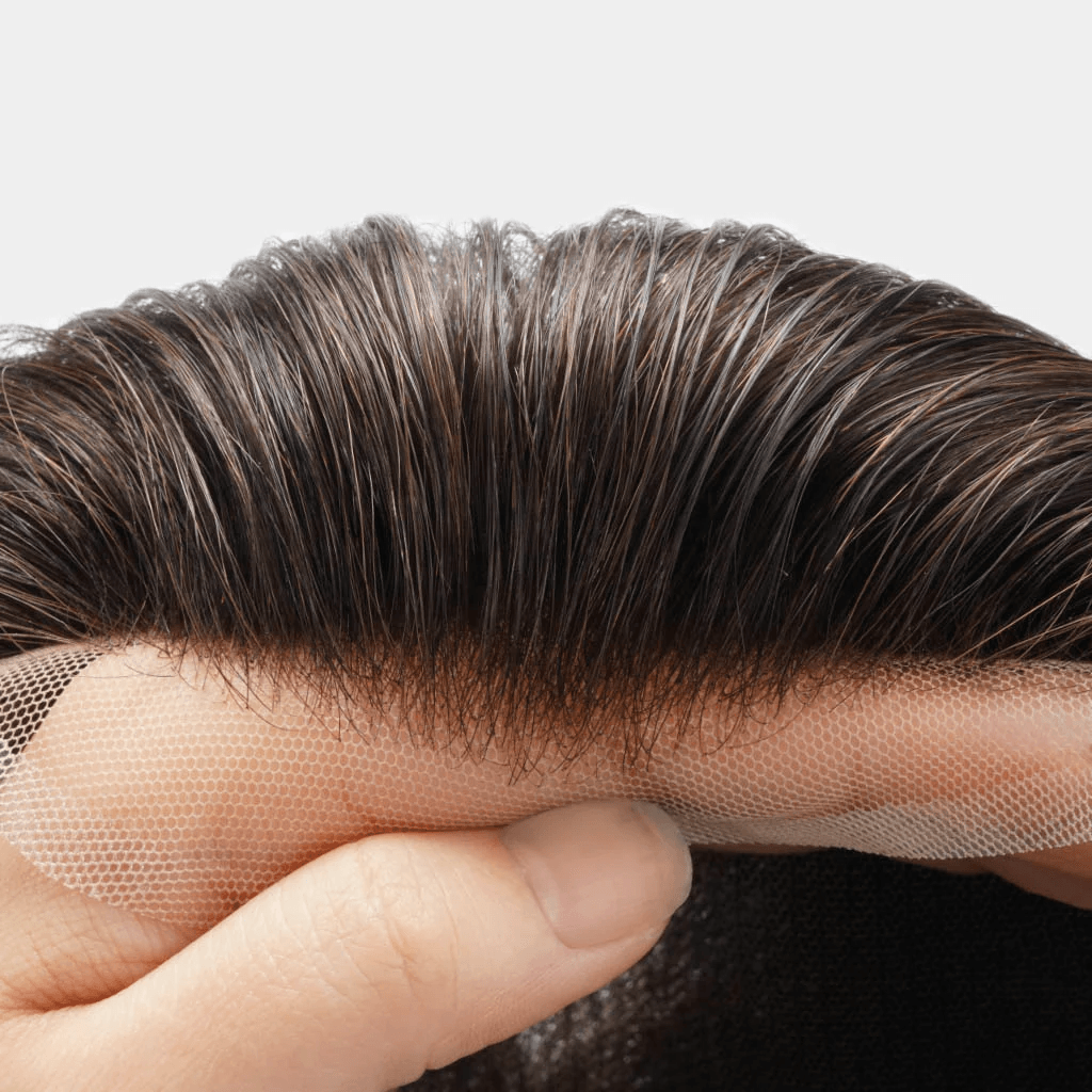 Close-up of a hair system’s lace front and individual hair strands